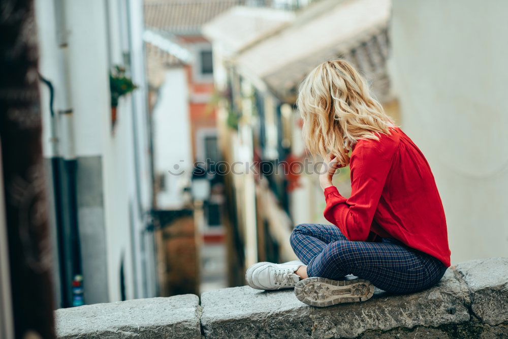 Image, Stock Photo Young woman sitting outdoors looking a beautiful narrow street