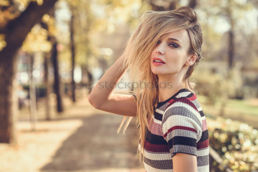 Image, Stock Photo Young blonde woman moving her hair in the street