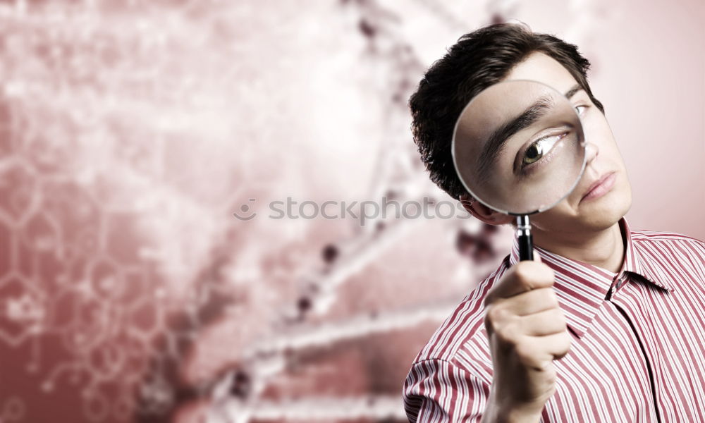 Similar – The man looking through a magnifier with suspicious