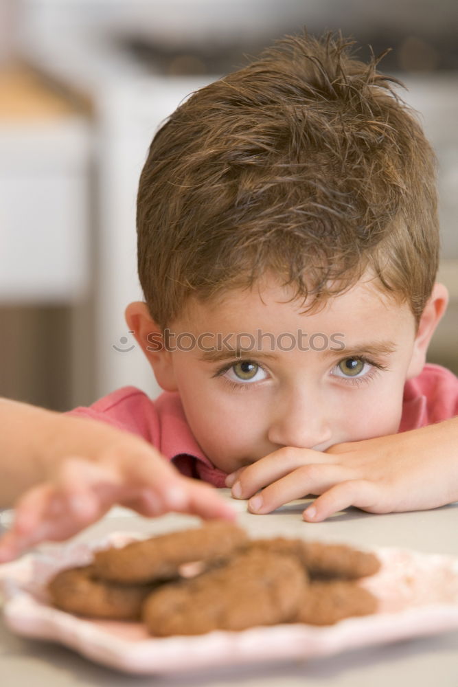 Similar – Girl decorating Christmas gingerbread cookies with chocolate