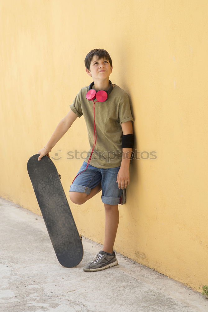 Similar – Close-up of a teenage boy carrying skateboard and smiling