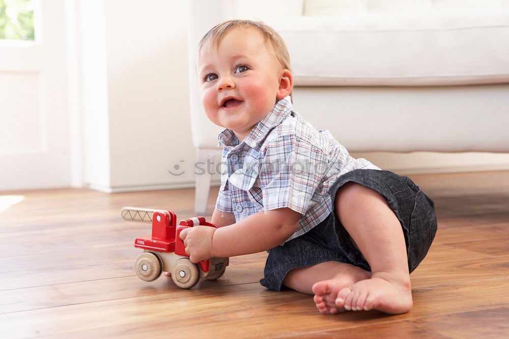 Similar – Toddler boy playing with new toy wearing pyjamas