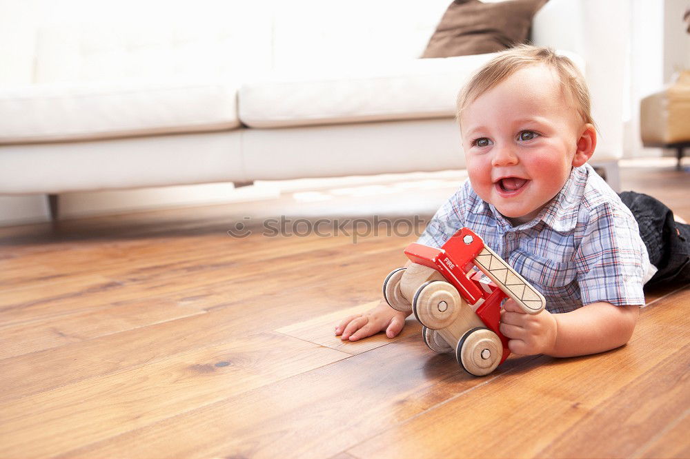 Similar – Toddler boy playing with new toy wearing pyjamas