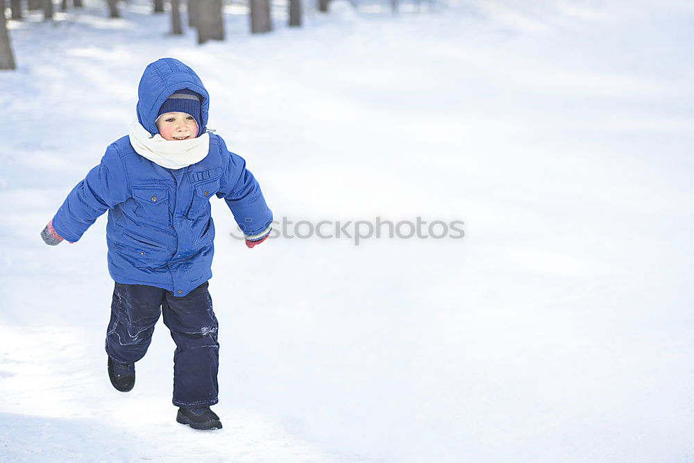 Similar – Little girl enjoying winter removing snow from a bench