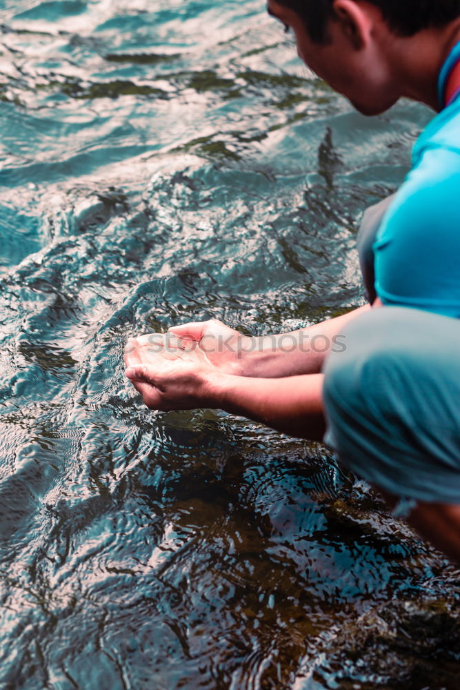 Image, Stock Photo Young boy taking pure water from a river in the hands