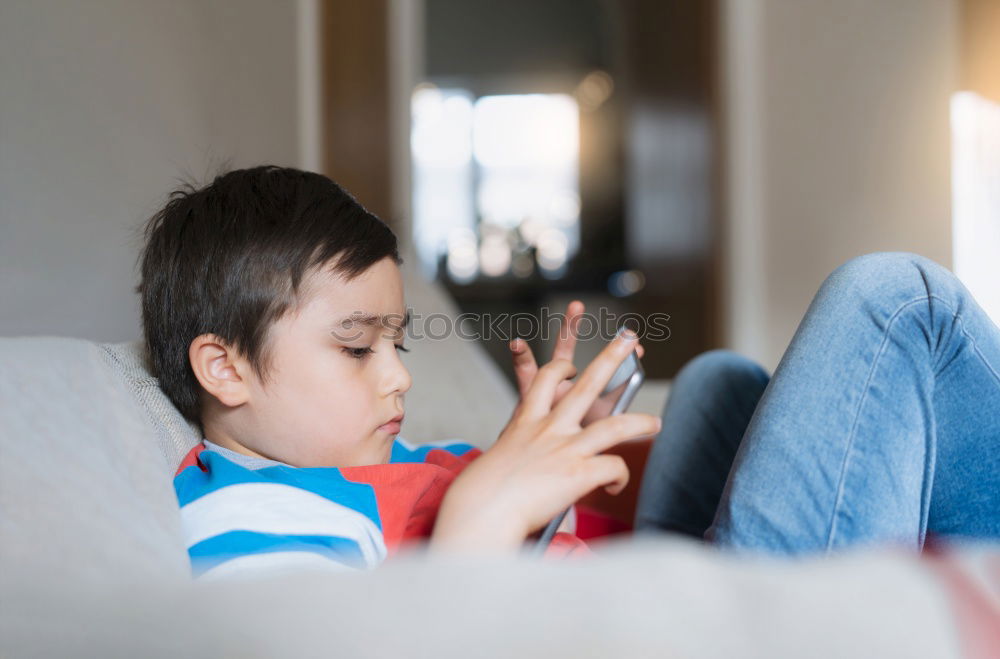 Similar – Mother reading a book to her baby son