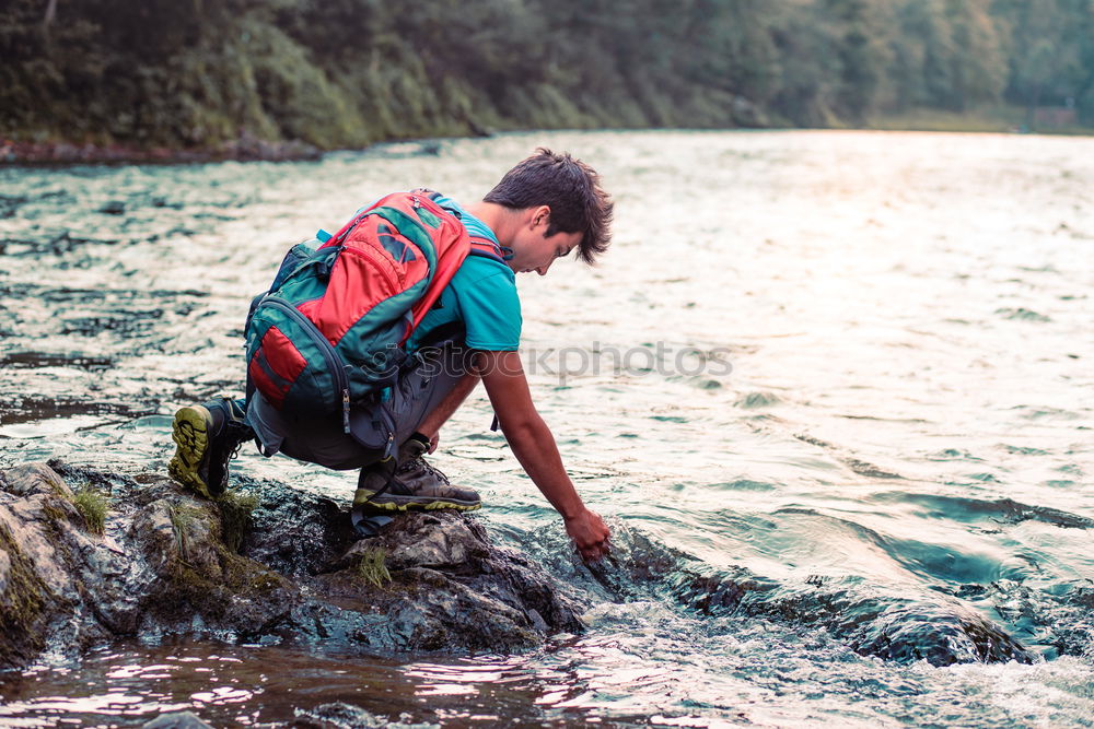 Similar – Young boy taking pure water from a river