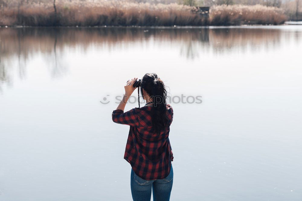 Similar – Image, Stock Photo Young woman is taking picture of sunset at the beach