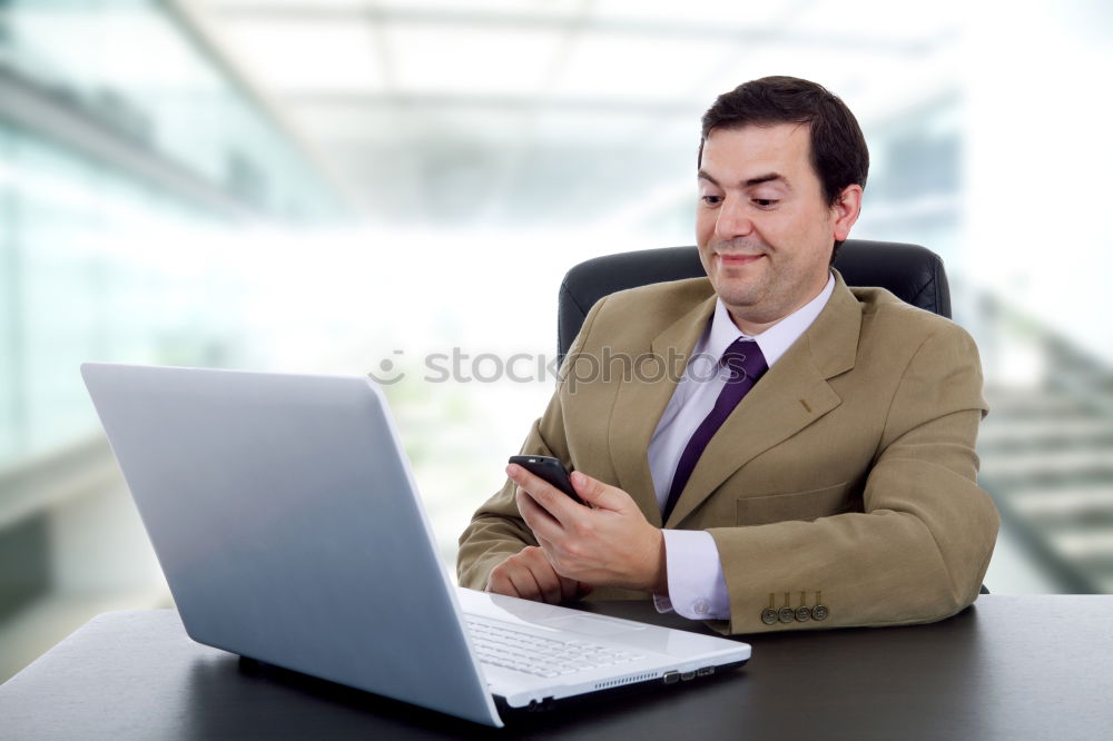 Similar – Image, Stock Photo Businessman enjoying coffee and checking his mobile phone for messages with a smile with his laptop and tablet open on the table