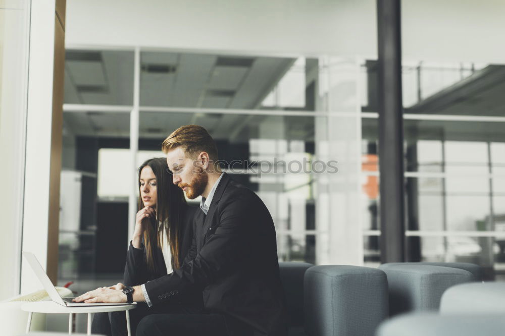 Similar – Geschäftsmann mit Blick auf das Smartphone im modernen Firmenbüro.