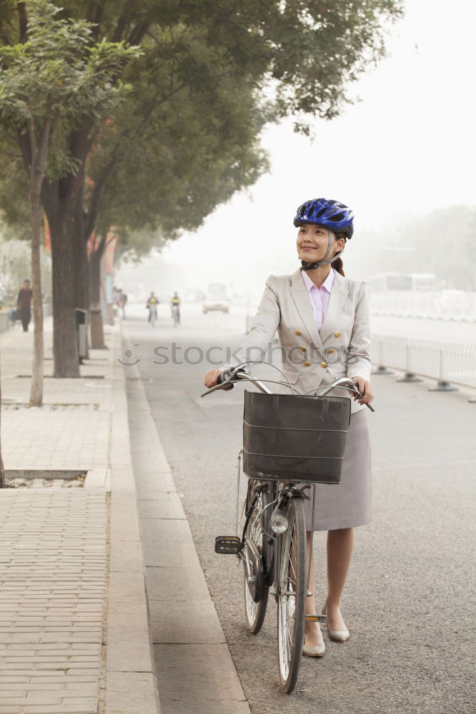 Similar – Handsome afro man walking with his bike.