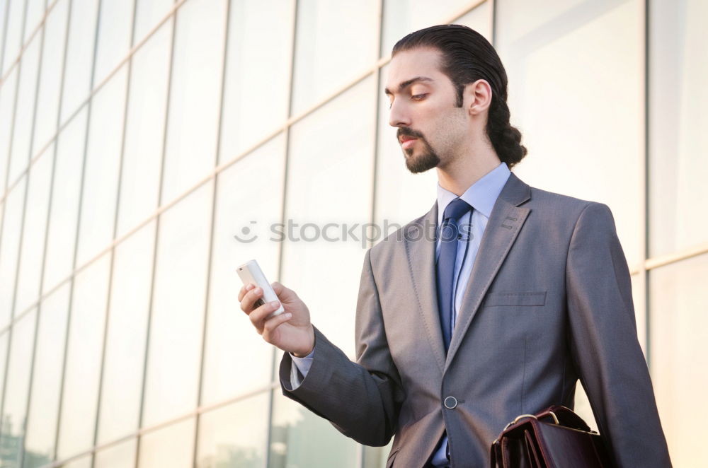 Similar – Image, Stock Photo Elegant Young Businessman in the Street Using a Mobile Phone