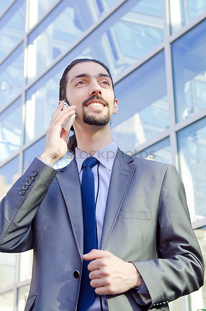 Similar – Image, Stock Photo Elegant Young Businessman in the Street Using a Mobile Phone