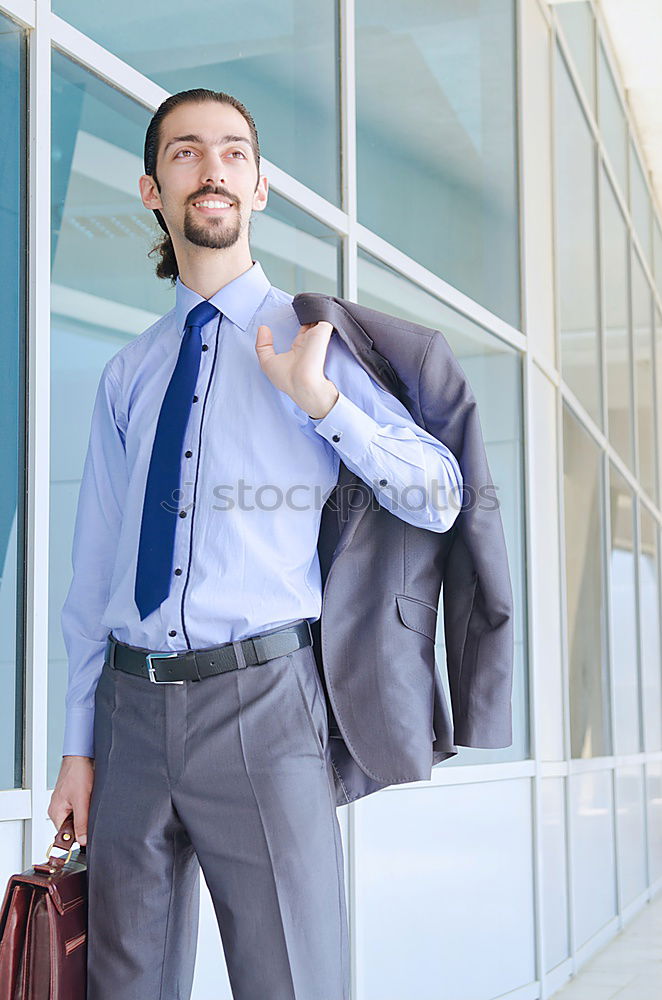 Similar – young businessman walking at the airport using his mobile phone