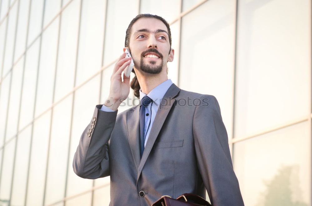 Similar – Handsome businessman walking in an urban street