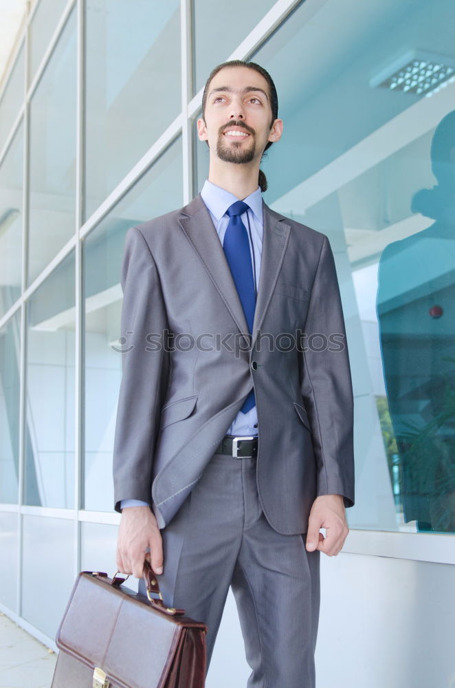 Similar – young businessman walking at the airport using his mobile phone