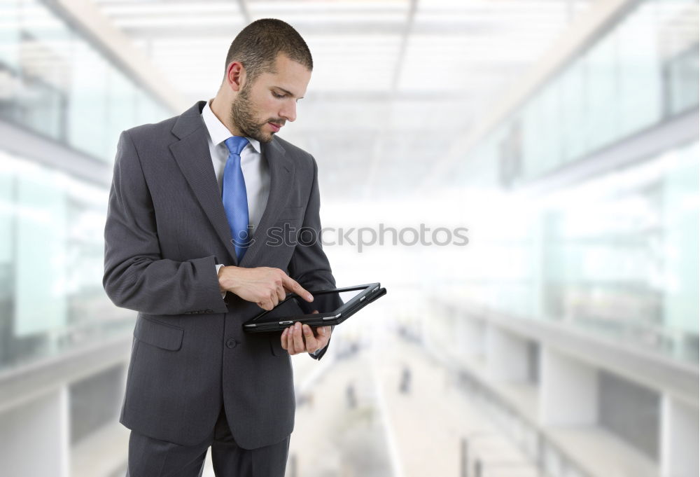 Similar – young businessman walking at the airport using his mobile phone