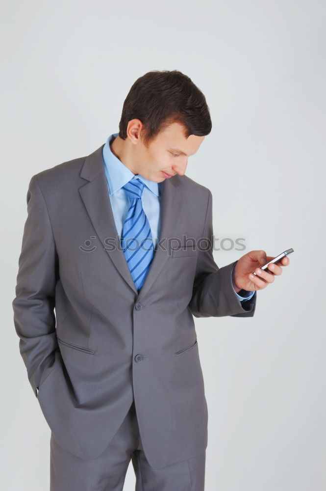 Similar – Image, Stock Photo Businessman Texting on his Phone in the Street