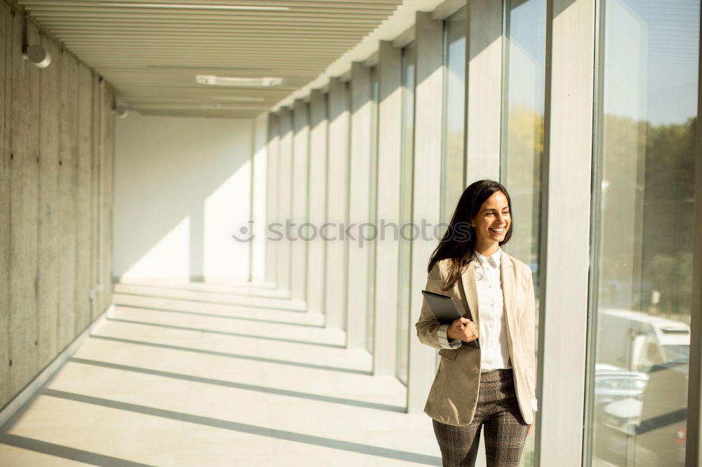 Similar – Image, Stock Photo black woman in the moving walkway at the airport with a pink suitcase.