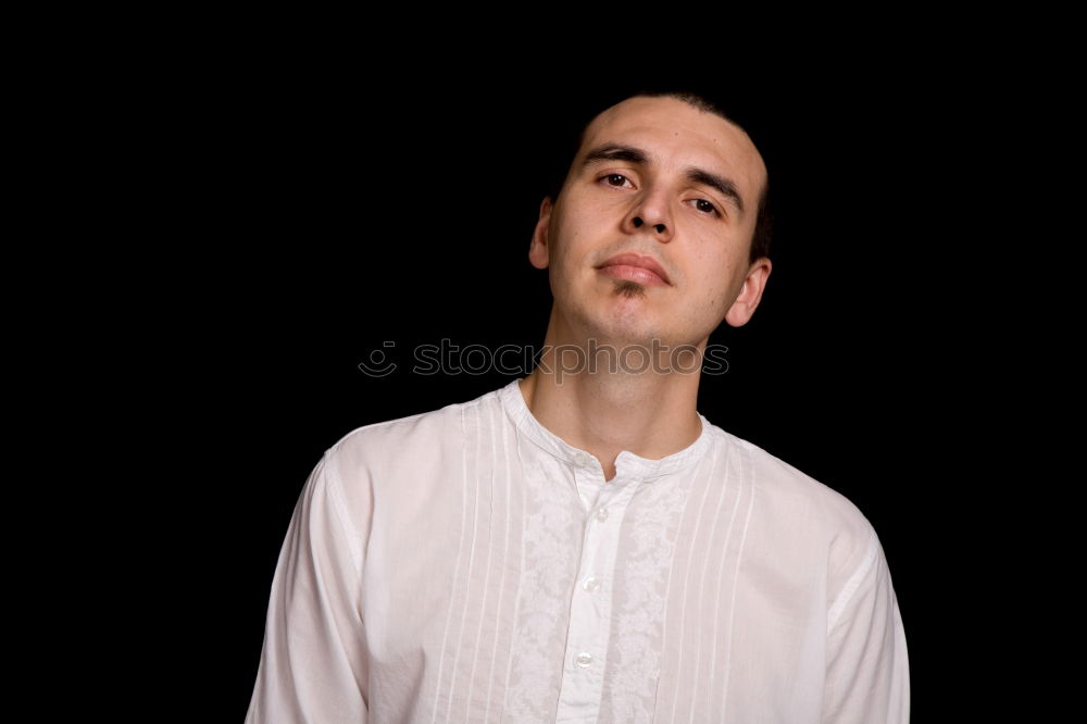 Similar – Boy with a white T-shirt in front of a dark wall