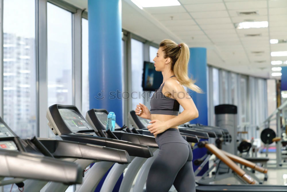 Similar – Woman training over treadmill on fitness center