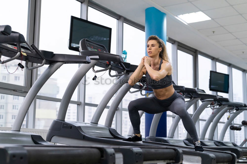 Similar – Woman training over treadmill on fitness center