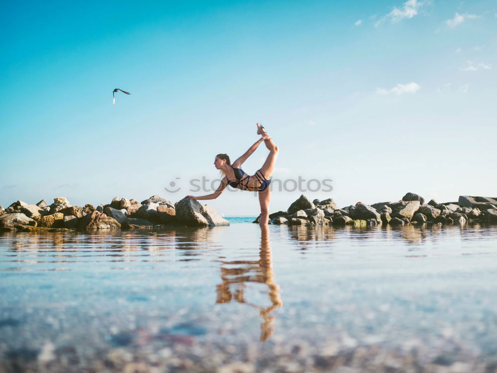 Similar – Image, Stock Photo Fit African woman doing yoga exercise on rocks by the beach