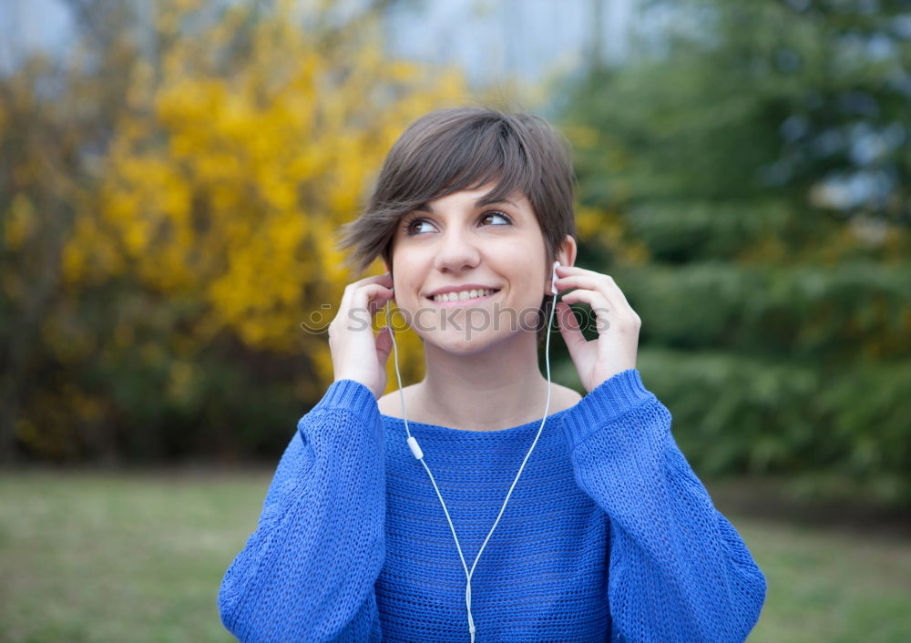 Similar – Two happy teenage girls lying on the grass sharing headphones to listen to music