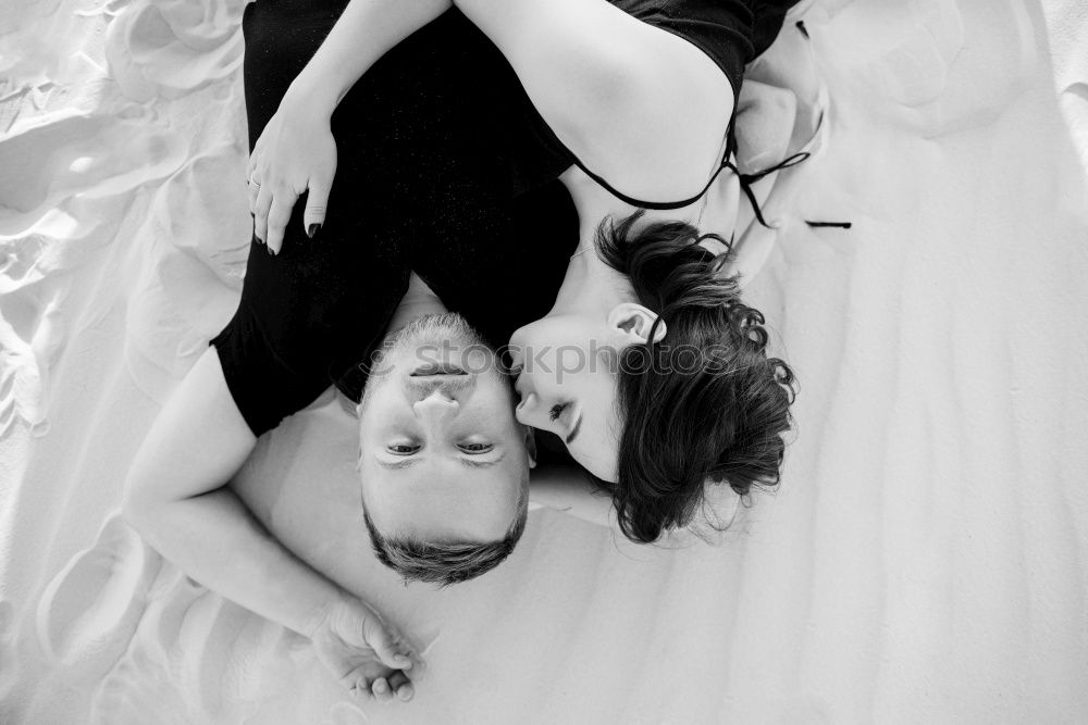 Similar – Two young women lie casually together on a bed with heads and look into the camera