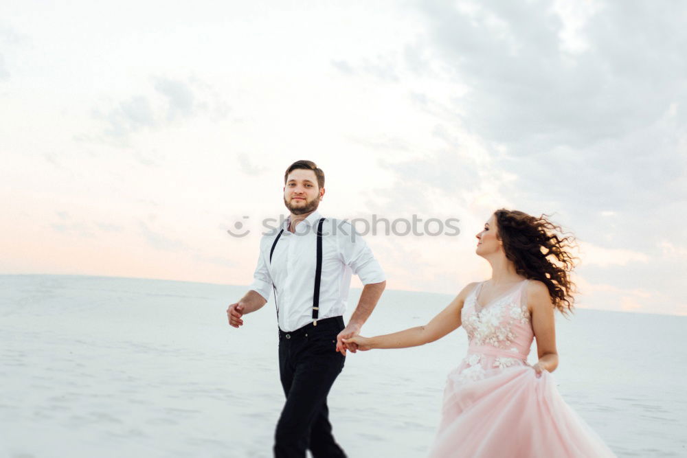 Similar – Bridal couple posing on sunny beach