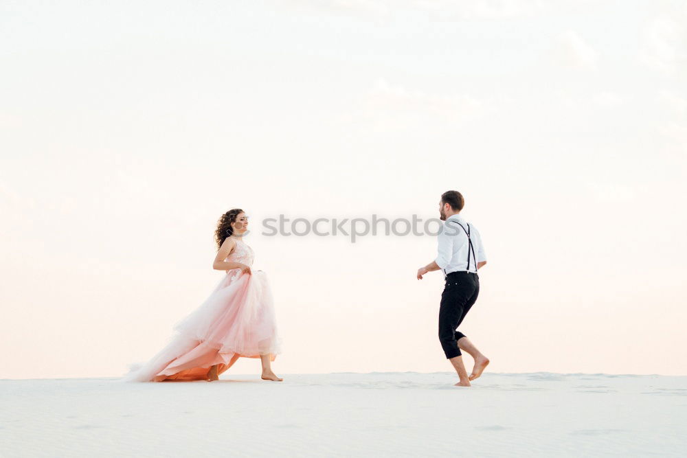 Similar – Bridal couple posing on sunny beach