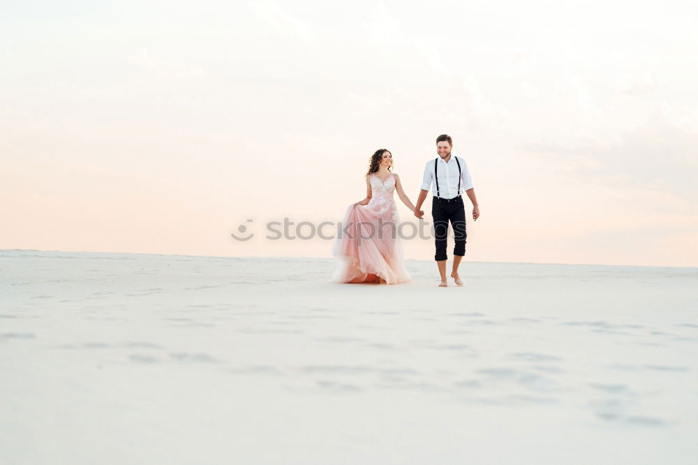 Similar – Bridal couple posing on sunny beach