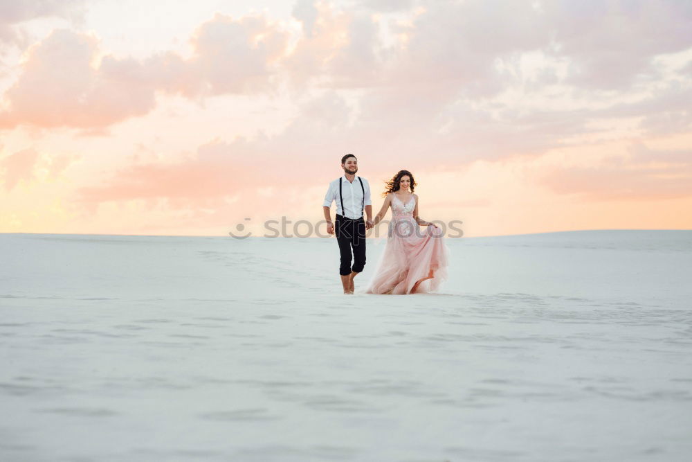 Similar – Bridal couple posing on sunny beach