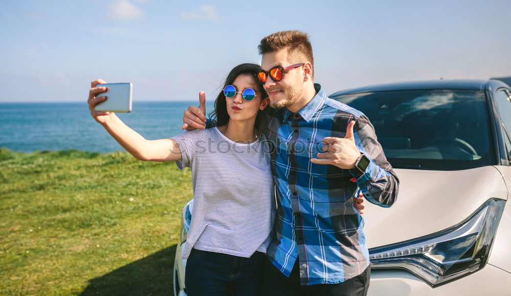 Similar – Young couple doing a selfie on the car