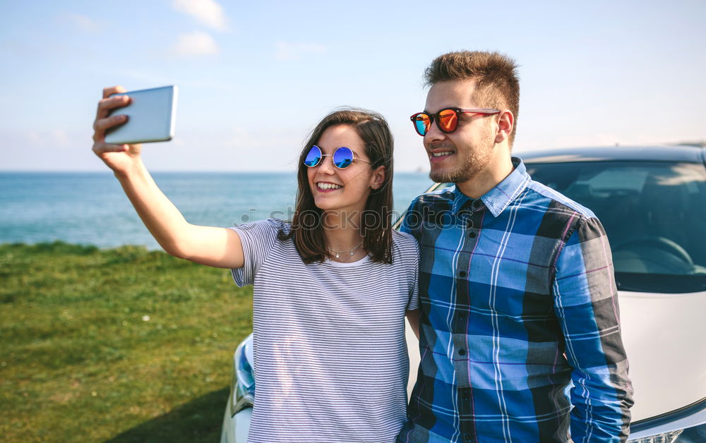 Similar – Young couple doing a selfie on the car