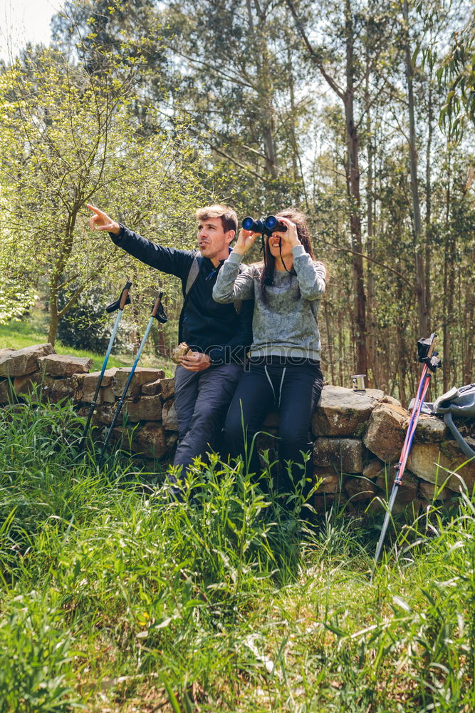 Similar – Image, Stock Photo Couple pausing while doing trekking