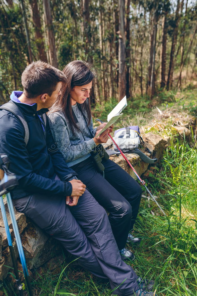 Image, Stock Photo Couple doing trekking sitting looking mobile and map