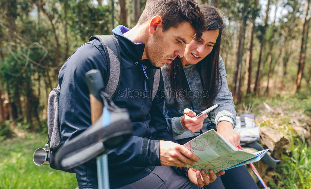 Image, Stock Photo Couple doing trekking sitting looking mobile and map
