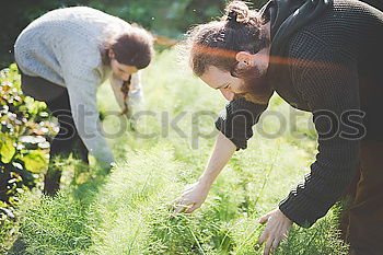 Image, Stock Photo Two supple athletic young women working out together in the countryside doing bending and stretching exercises