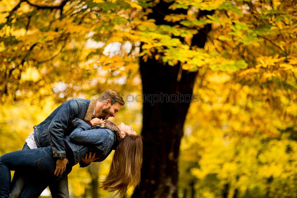 Similar – Couple makes a leaf fight in autumn