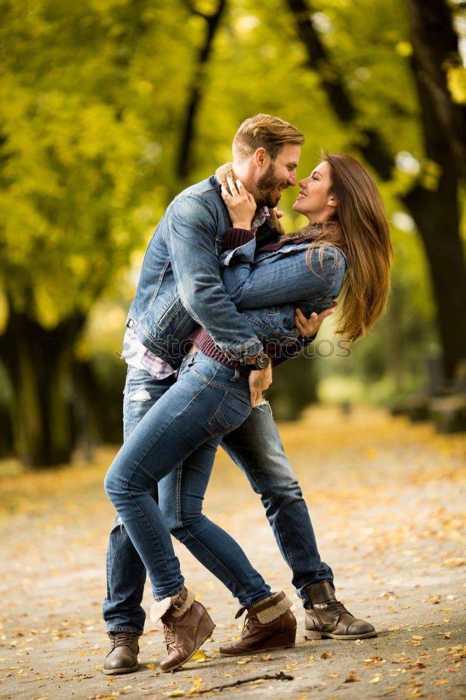 Similar – Couple makes a leaf fight in autumn