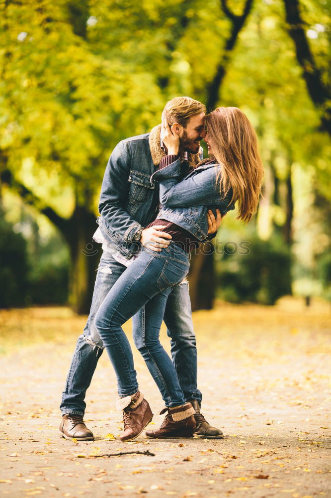 Similar – Couple makes a leaf fight in autumn