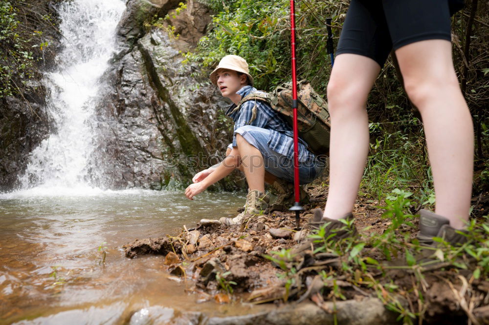 Similar – young woman standing in front of tropical waterfall