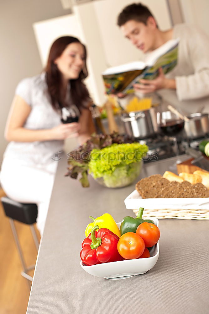 Similar – Image, Stock Photo Young couple cooking. Man and woman in their kitchen