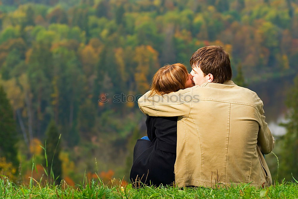 Similar – Image, Stock Photo 2 seniors in love are sitting on a bench in the vineyard and look into the Ahr valley. The man points to something.