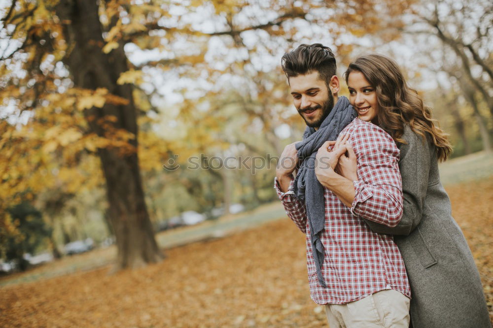 Blonde girl looks at camera while embraces her bearded boyfriend.