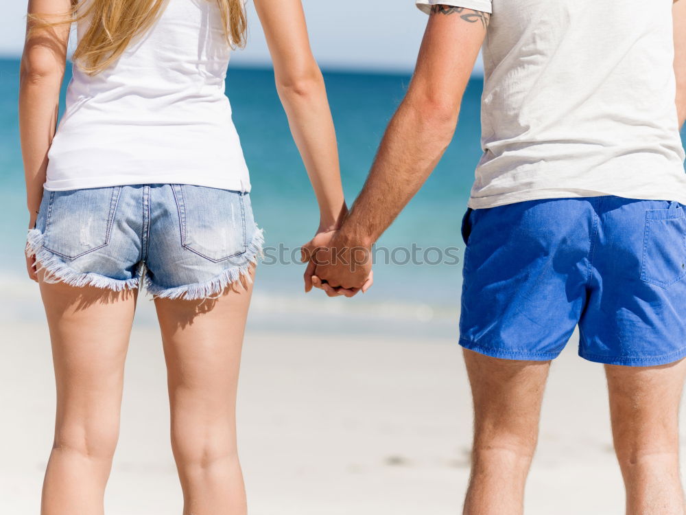 Similar – Closeup of couple holding hands