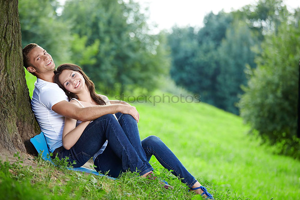 Similar – Happy smiling couple laying on green grass