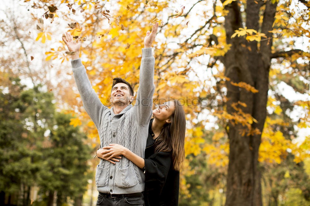 Couple makes a leaf fight in autumn