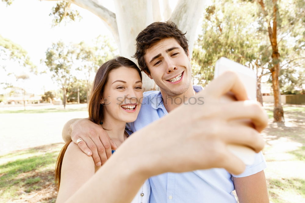 Similar – Image, Stock Photo Romantic Young Couple taking a photo with mobile phone.